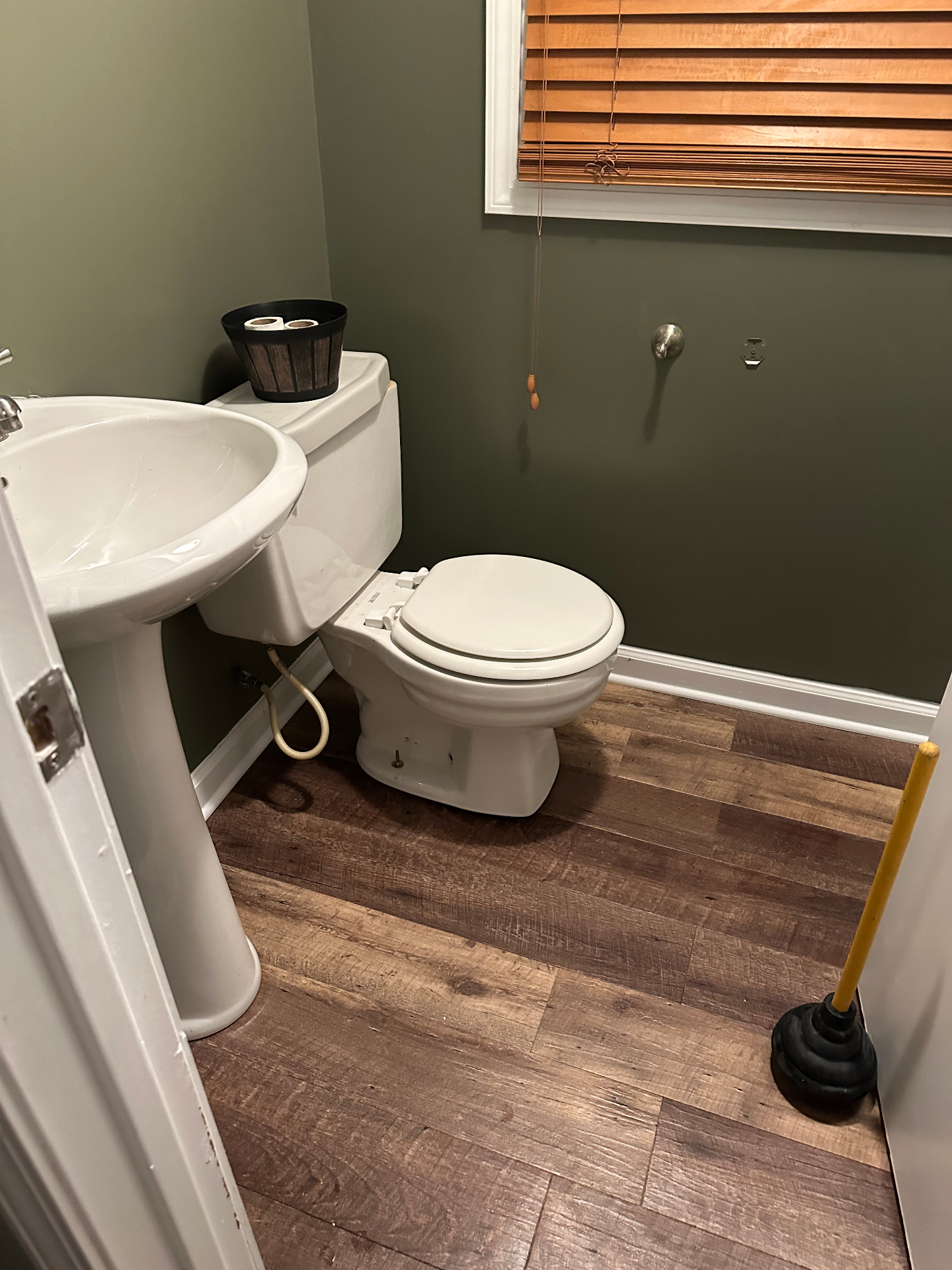 New wood-look vinyl plank flooring installed with fresh trim